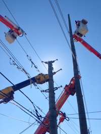 Crews installing anew 60 foot pole 