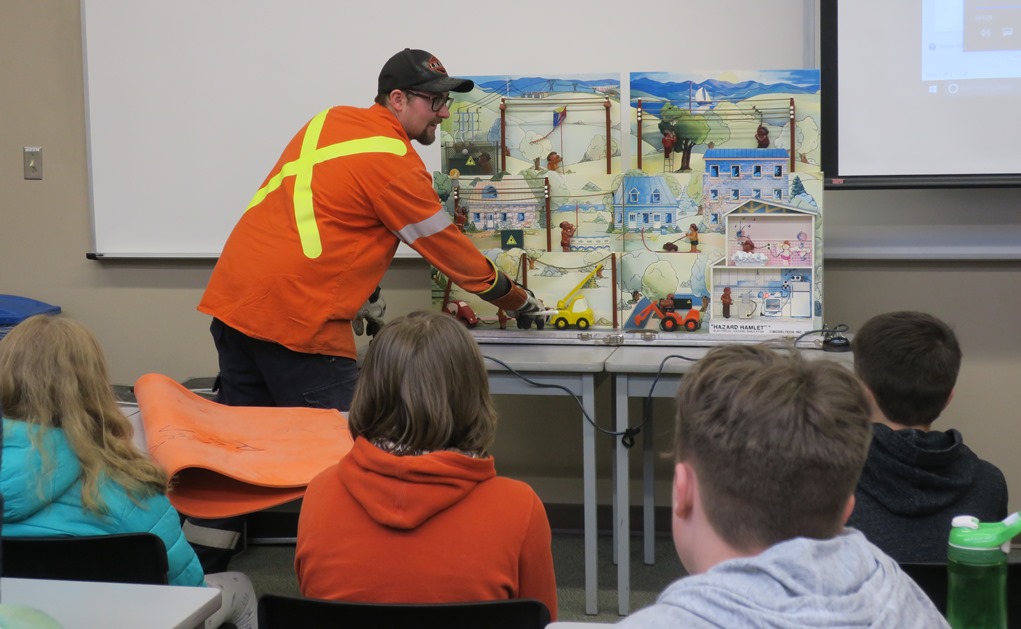 A journeyperson with Utilities Kingston presents to students on electrical safety.