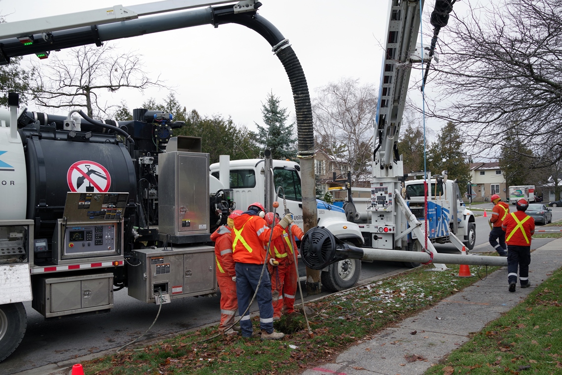 The underground group assists the streetlight crew by excavating a pole hole, using the hydro vac truck.