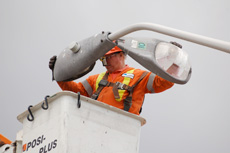 UK technician installing LED street light