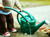 little hands helping with the watering hose and can