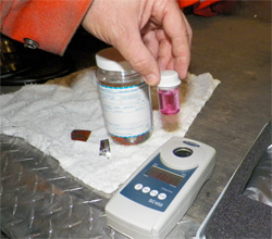 An operator tests water sample for chlorine