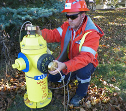 Utilities Kingston worker listening for water leaks