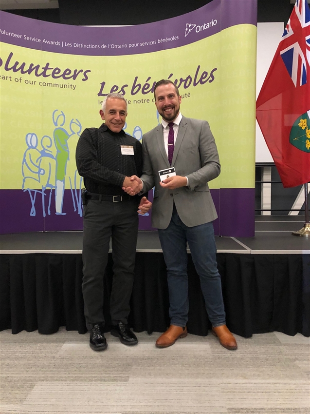 MPP Ian Arthur (right), presents Chico with a pin.